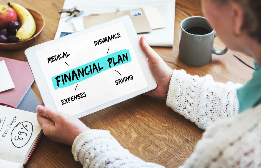 Person reviewing a financial planning checklist with a laptop and calculator on a desk